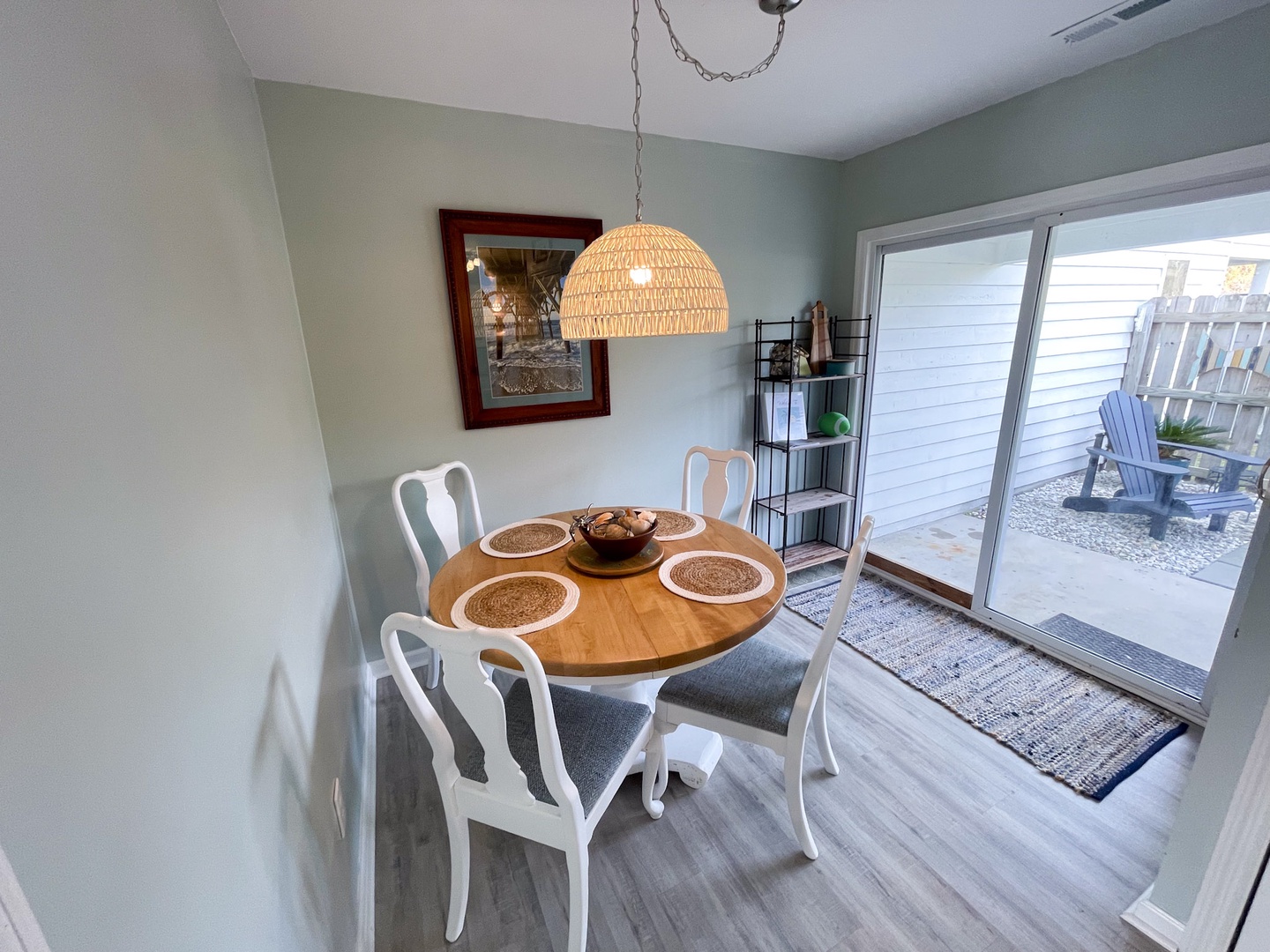 Share memorable meals at your elegant round dining table, perfectly lit by coastal wicker lighting with peaceful patio views.