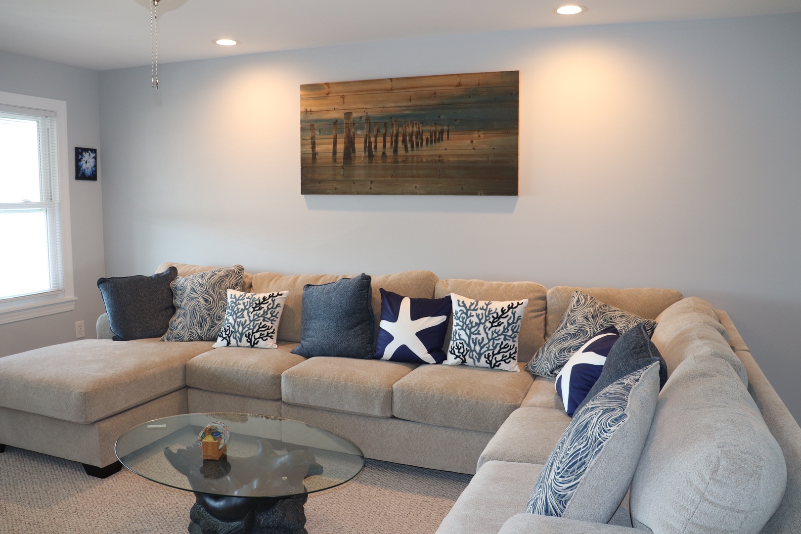 Sink into this cozy sectional sofa where coastal charm meets comfort. Nautical accents and soothing blues create your perfect retreat for unwinding after beach days.