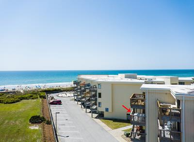 Beachfront property buildings with direct ocean access and coastal views in a scenic seaside location.