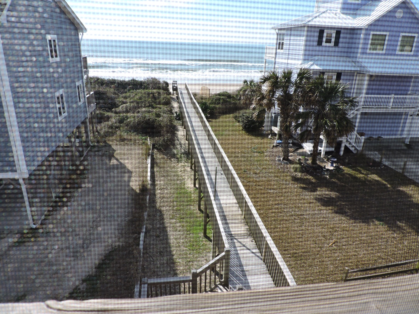 Oceanfront community with elevated walkway leading directly to pristine beach access through natural dunes.