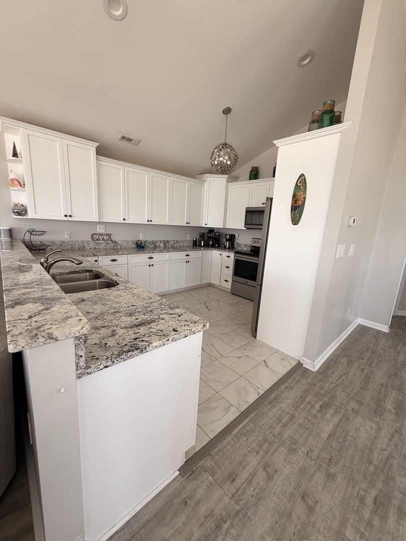 Your fully equipped kitchen features elegant granite countertops, modern appliances, and ample cabinet space—perfect for whipping up meals during your stay.