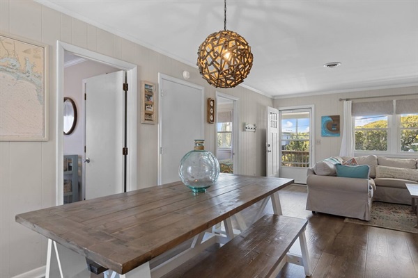 Gather around this beautiful dining table where meals become memories, with natural light streaming through windows.