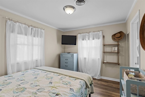 Your peaceful bedroom retreat features soft linens and coastal charm, creating the perfect space to unwind after your adventures.