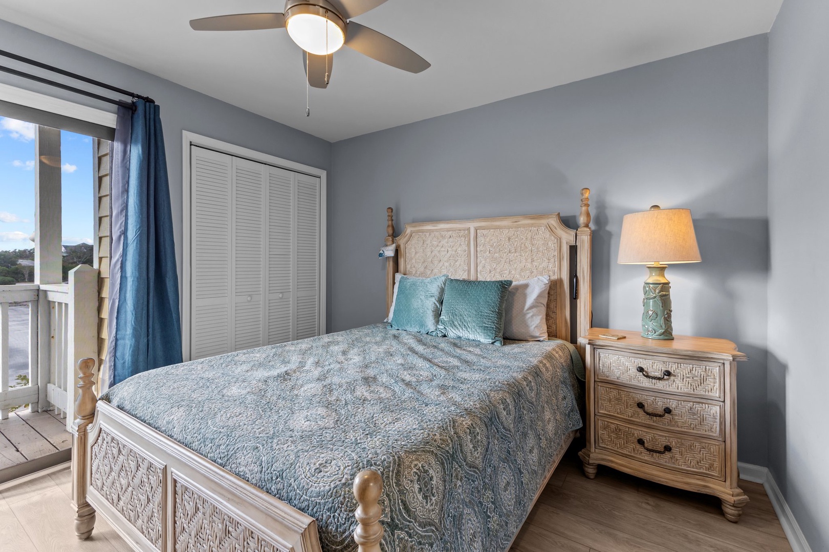 Drift off peacefully in your coastal-inspired bedroom with soft blue linens and ocean breezes from your private balcony.