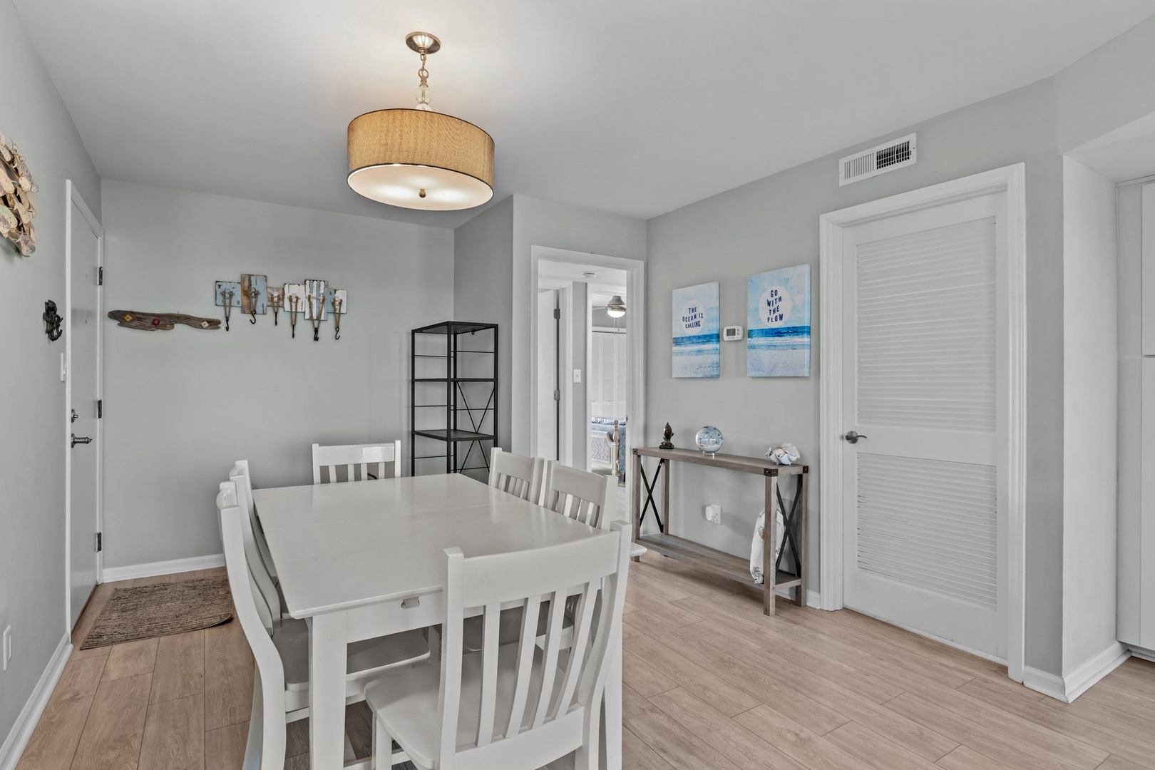 Gather around this bright dining space where coastal charm meets comfort. Your family meals become memorable moments here.