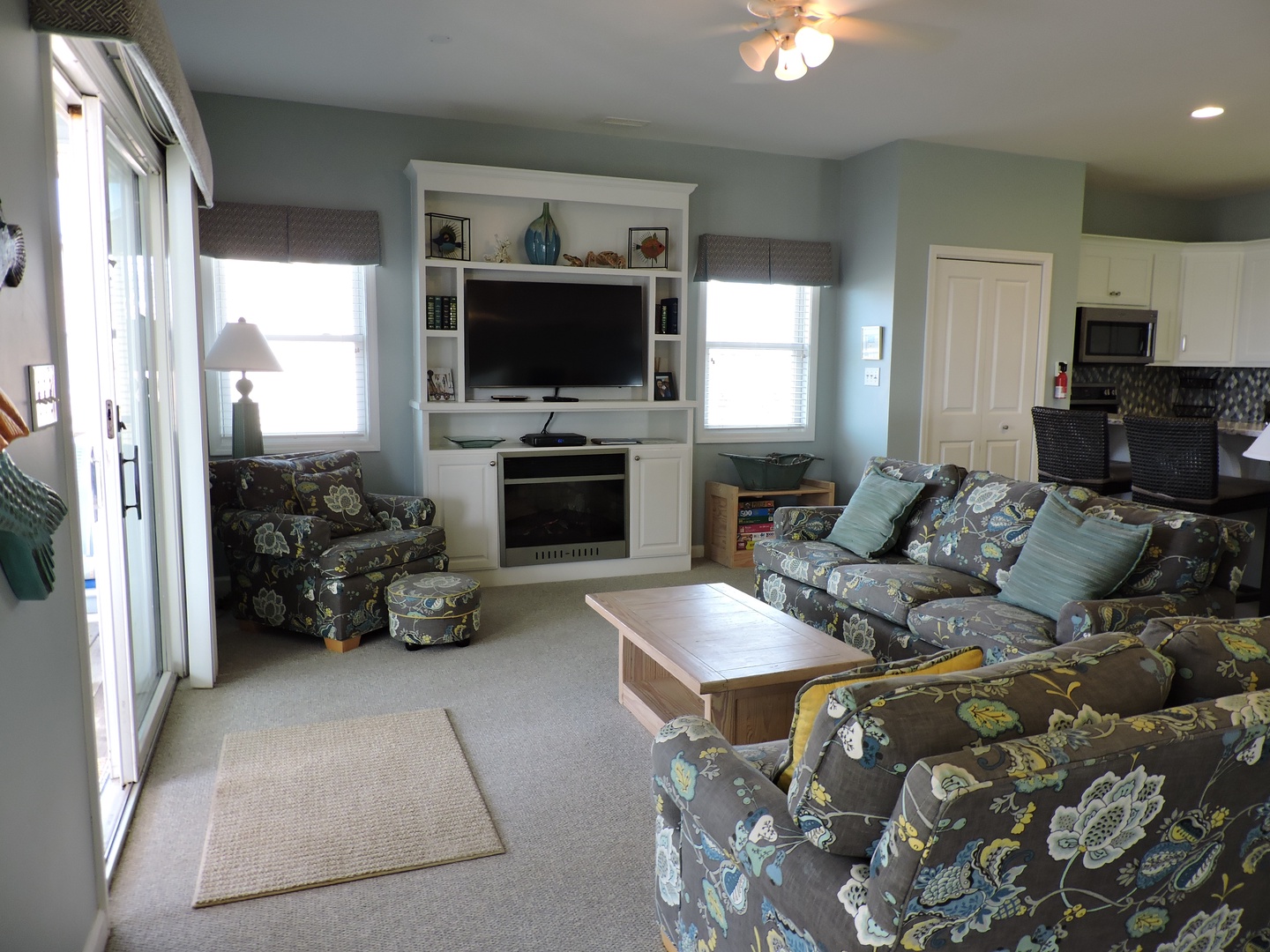 Sink into plush floral seating while you unwind by the fireplace, with your favorite shows on the built-in entertainment center.