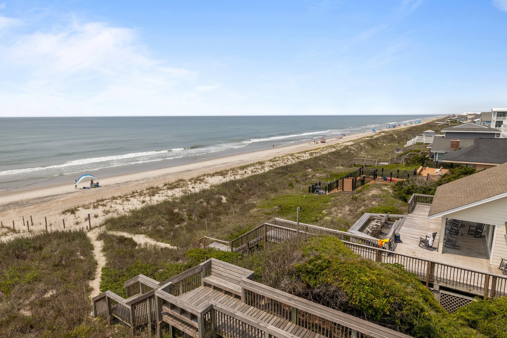 Oceanfront vacation rental with direct beach access via private boardwalk and stunning coastal views.