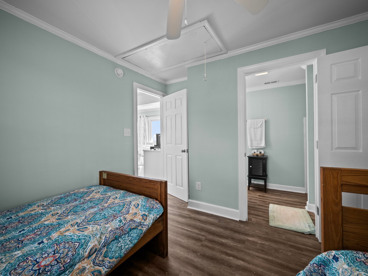 Relax in your serene bedroom with calming mint walls and beautiful coffered ceilings, complete with an ensuite bathroom for your convenience.