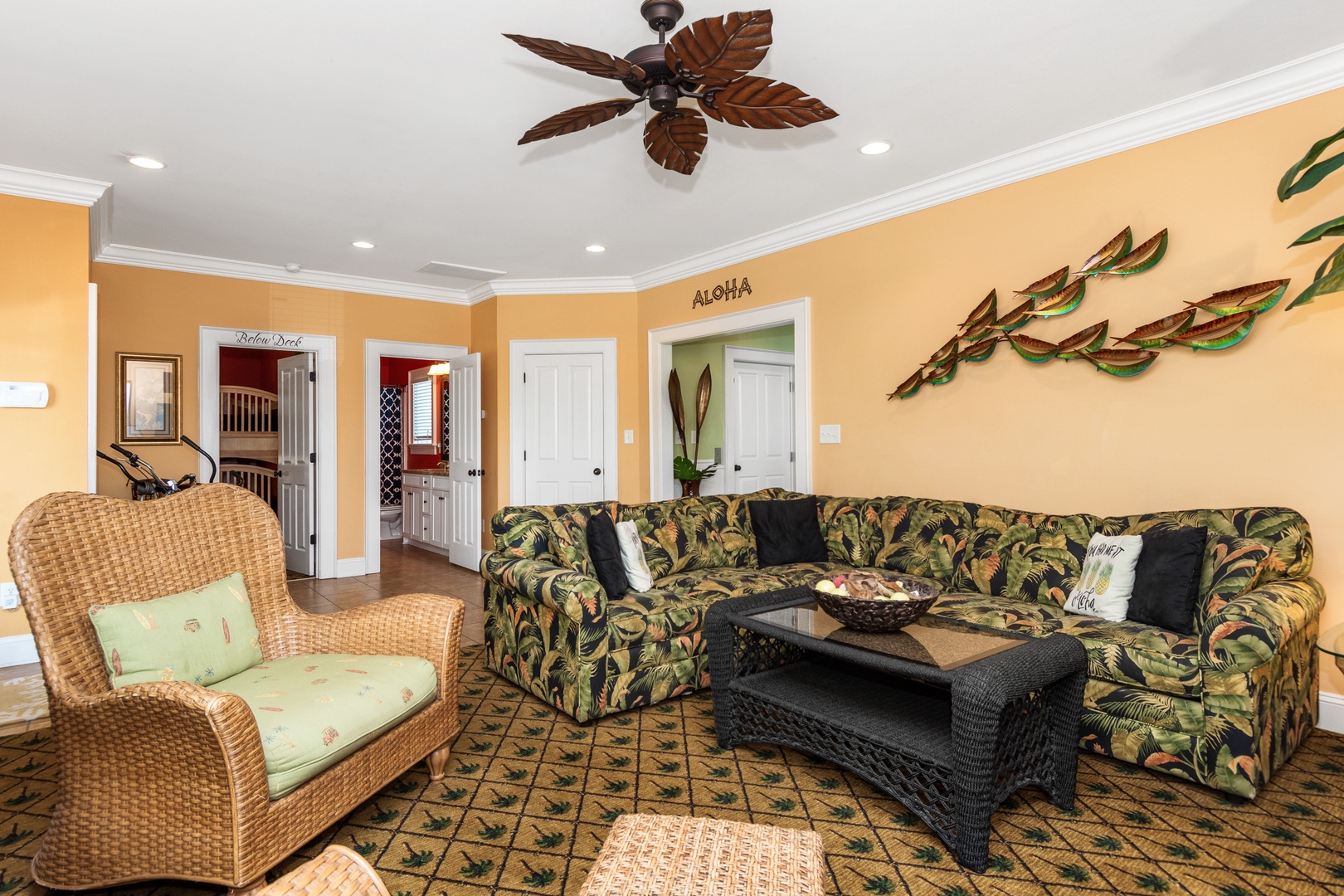 Sink into tropical comfort in your Hawaiian-themed living space, where leaf-pattern furnishings and warm colors create the perfect island escape.