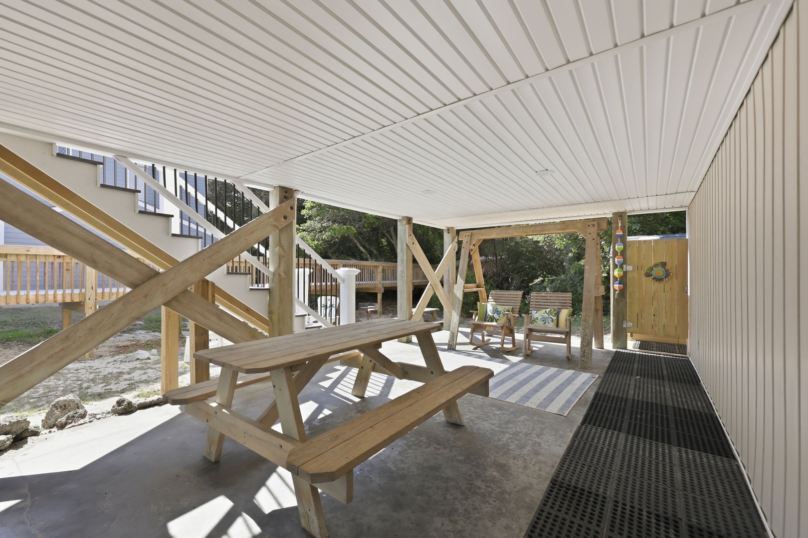 Your covered outdoor oasis awaits with picnic seating and a cozy dining area—perfect for morning coffee or evening gatherings under the shade.