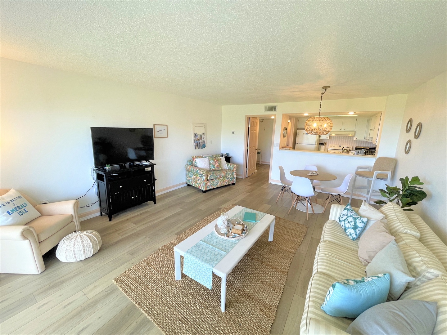 Relax in your bright, coastal-inspired living space with comfortable seating and a fully equipped kitchen ready for your culinary adventures.