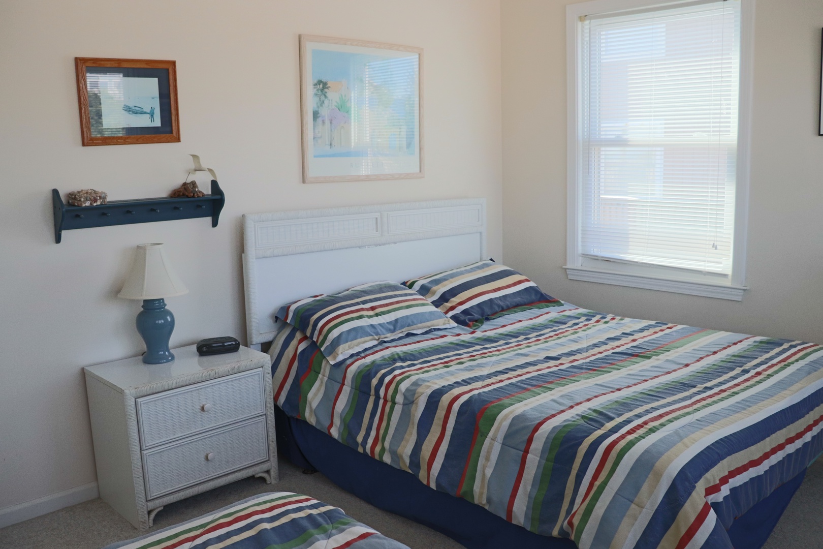 Drift off to sleep in this cheerful bedroom where coastal artwork and striped bedding create your perfect seaside retreat.