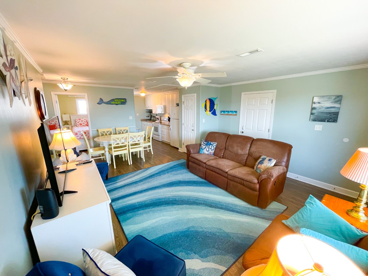 Your coastal living room flows seamlessly into the dining and kitchen areas, creating the perfect space to unwind after beach adventures.