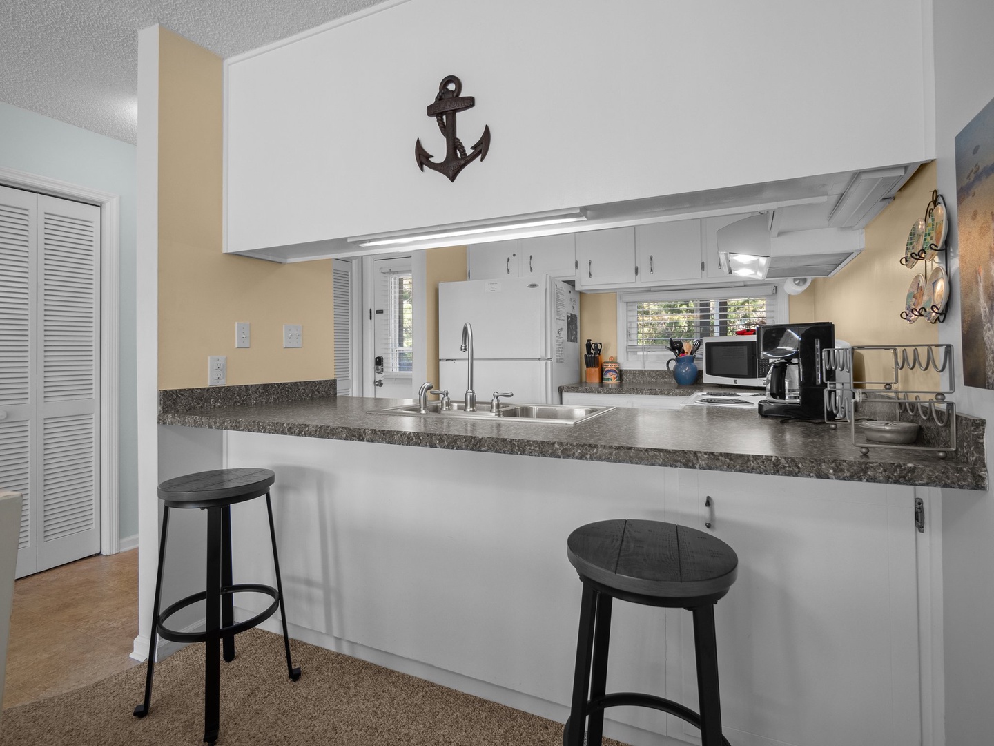 Your fully equipped kitchen with granite counters and nautical charm invites you to prepare meals and gather around the breakfast bar.