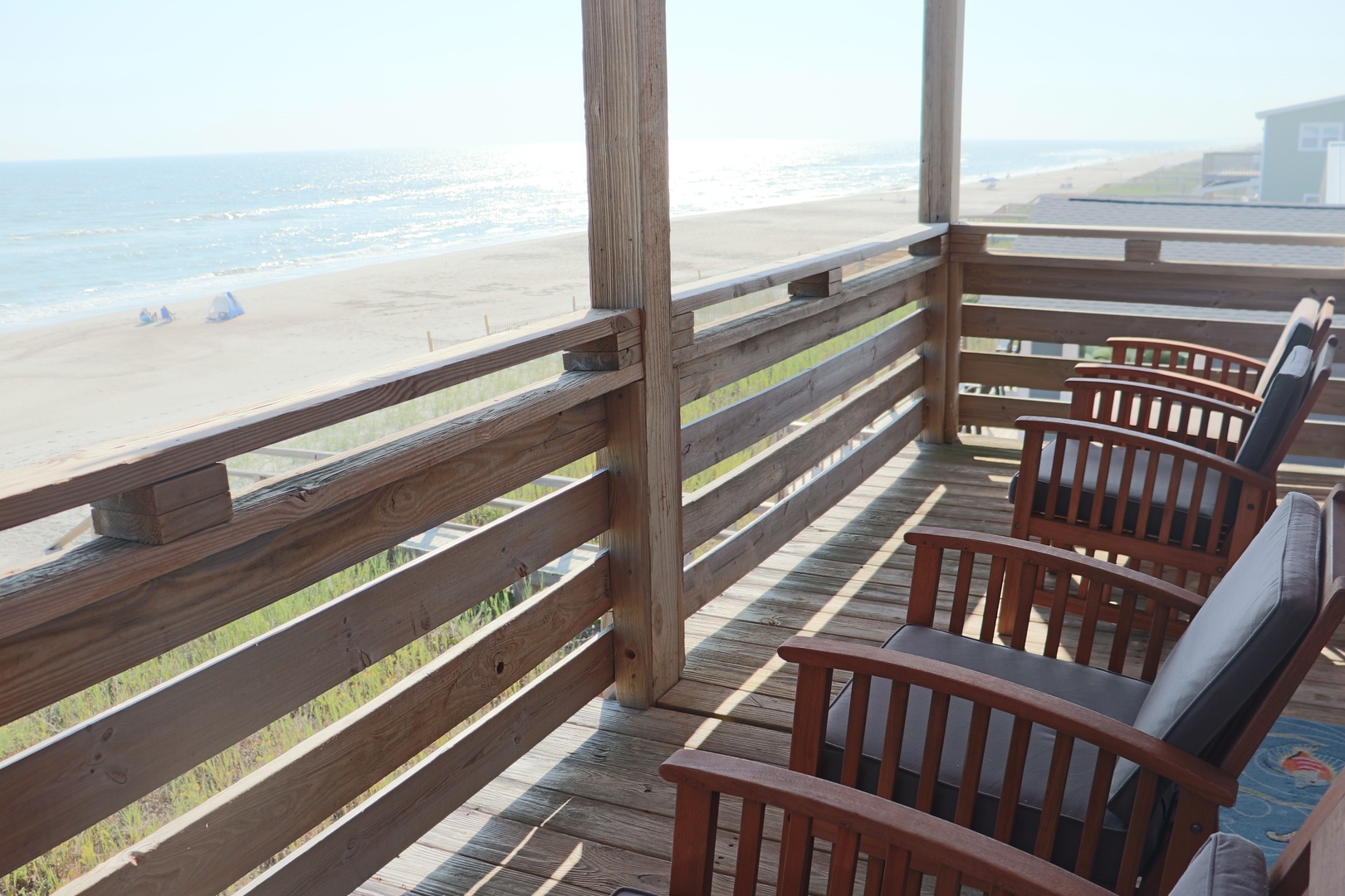 Relax on your private balcony with stunning ocean views, watching waves roll onto the sandy shore below.