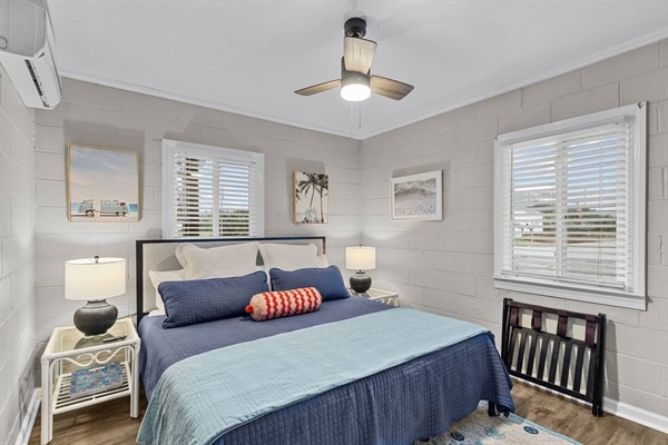 Drift off in your serene coastal bedroom with soft blues and gentle breezes from the ceiling fan above.