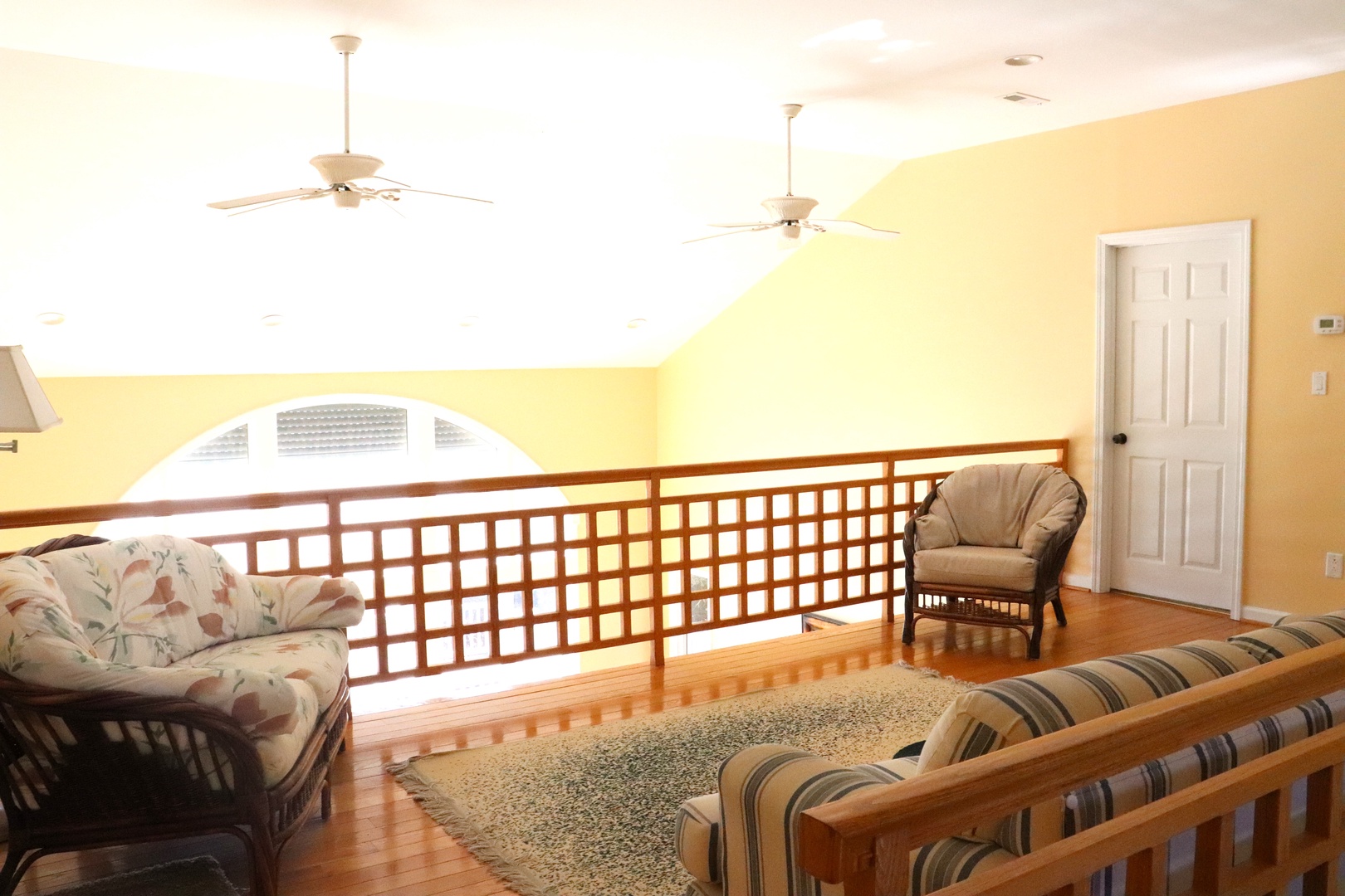 Unwind in your bright loft lounge with ceiling fans and tropical furnishings, perfect for relaxing after beach adventures.