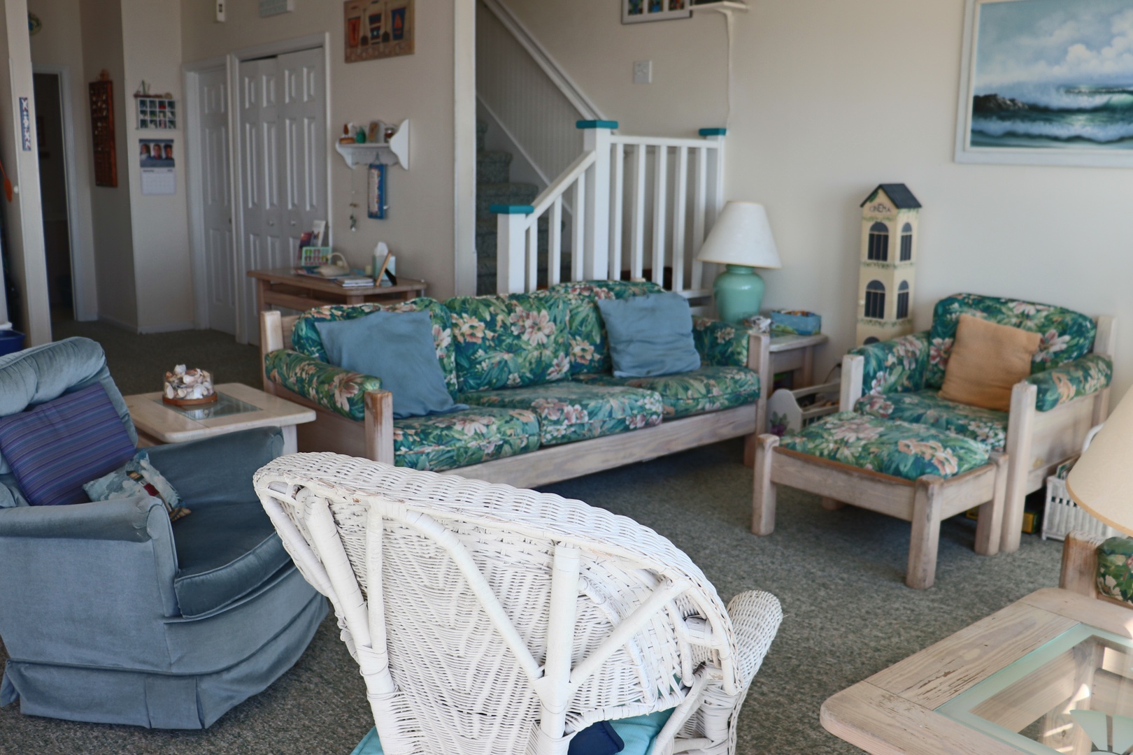 Settle into your coastal retreat's bright living room, where tropical florals and ocean blues create the perfect backdrop for lazy afternoons.