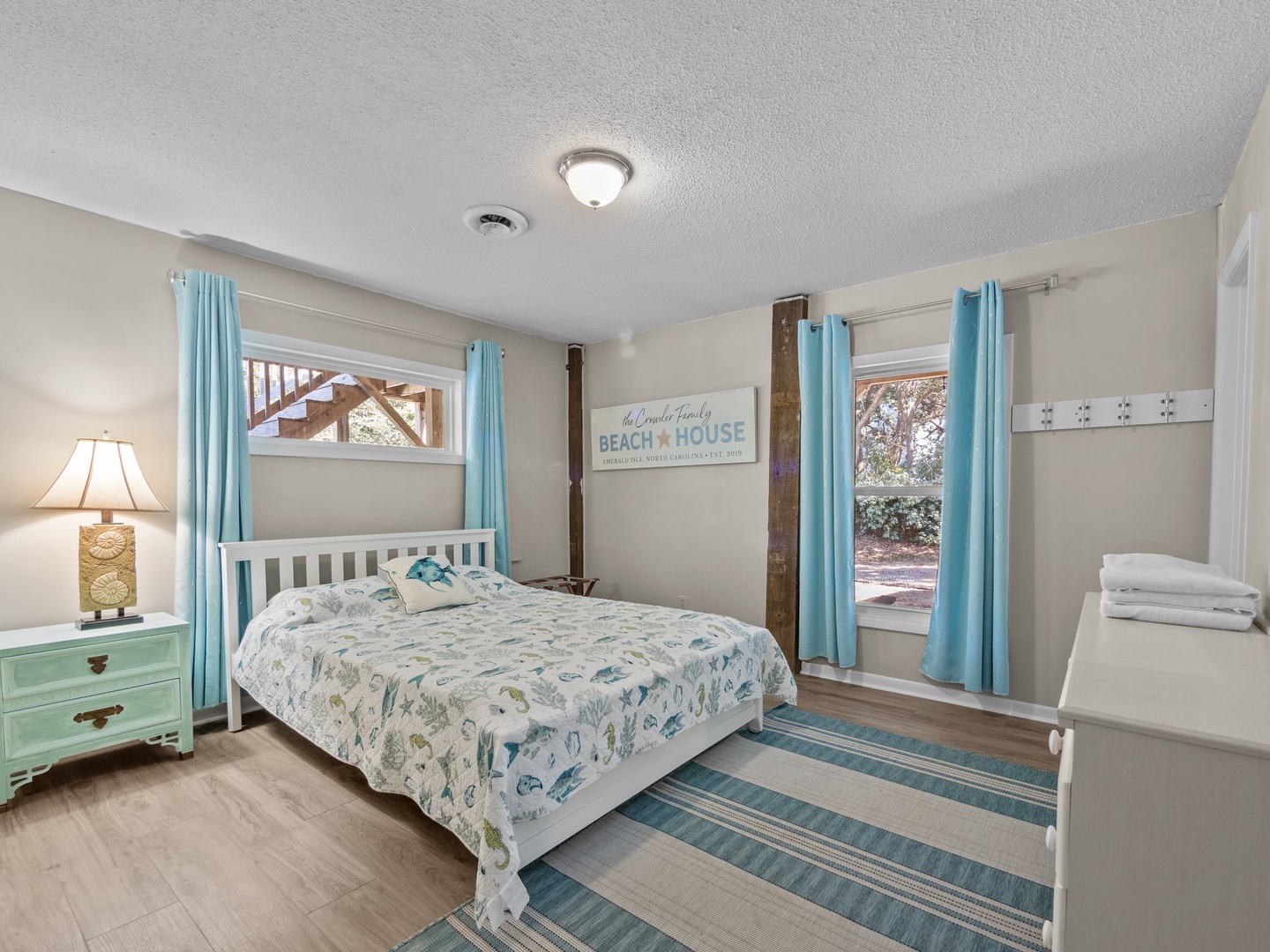 Drift off in your coastal-themed bedroom with ocean-blue accents and charming beach house details creating the perfect seaside retreat.