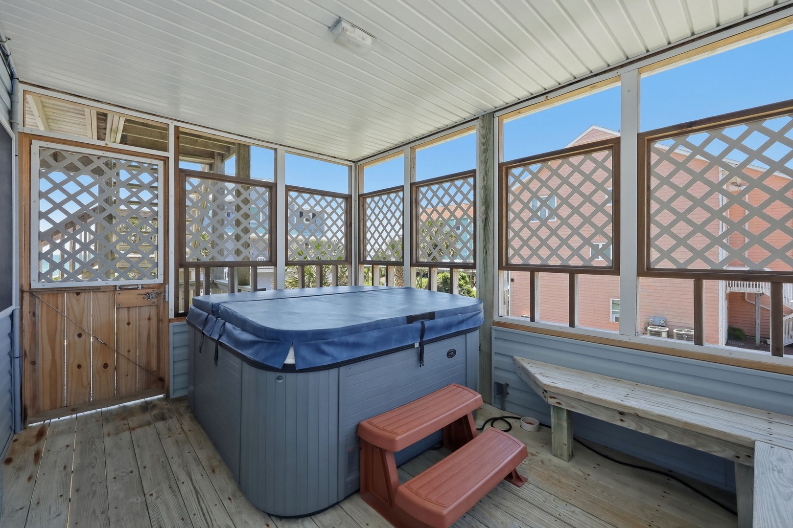 Soak away your cares in your private screened hot tub with lattice screens for added privacy, perfect for unwinding after a day of exploring the area.