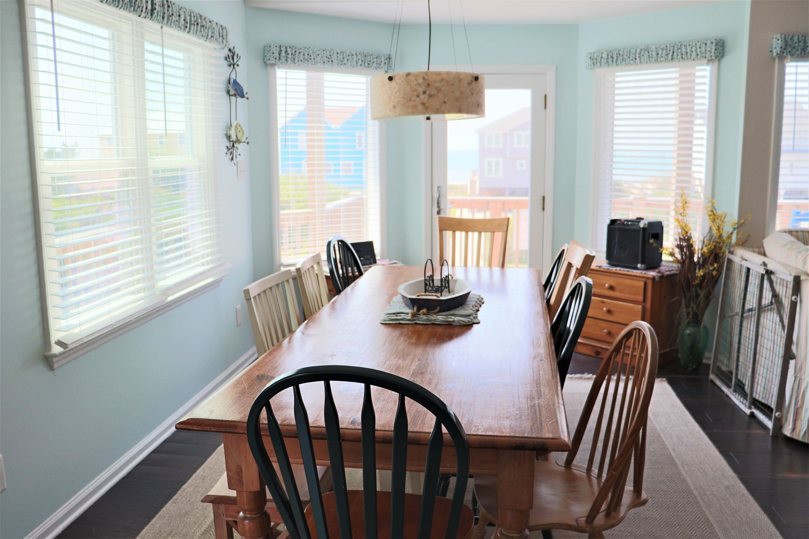 Gather around this spacious dining table where you'll share memorable meals with natural light streaming through large windows.