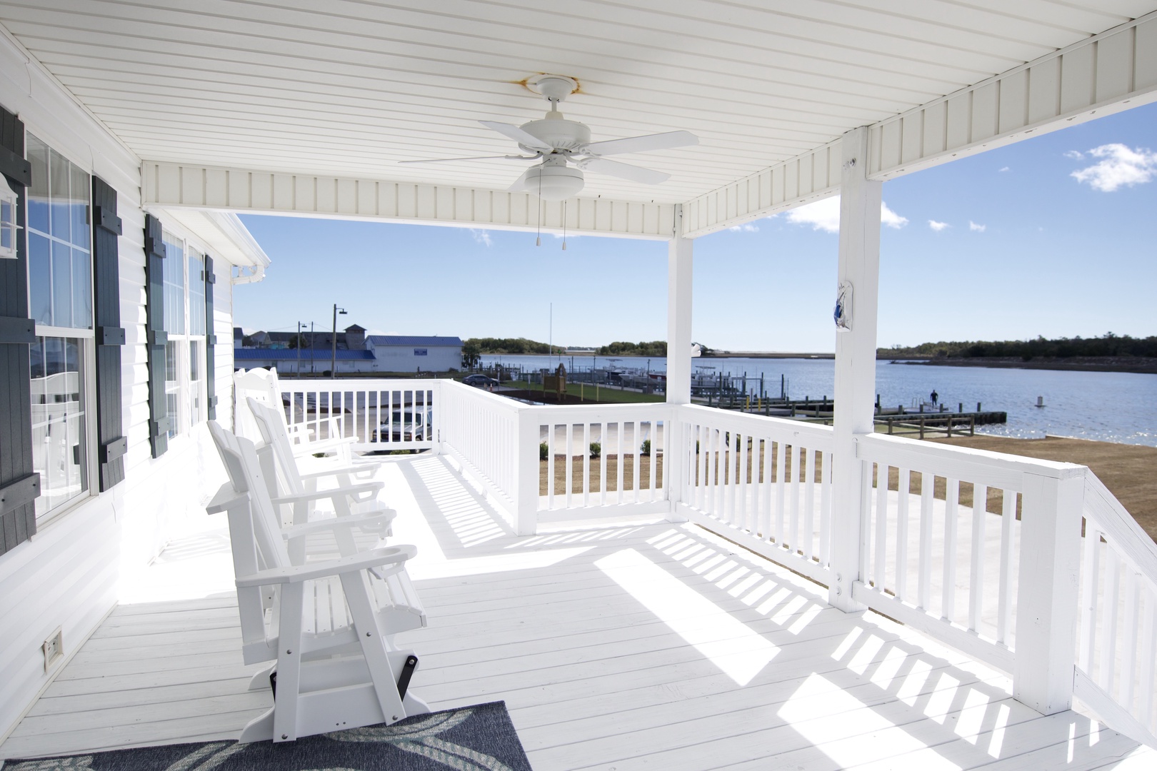 Your covered deck invites morning coffee and evening sunsets, with comfortable seating overlooking peaceful water views.