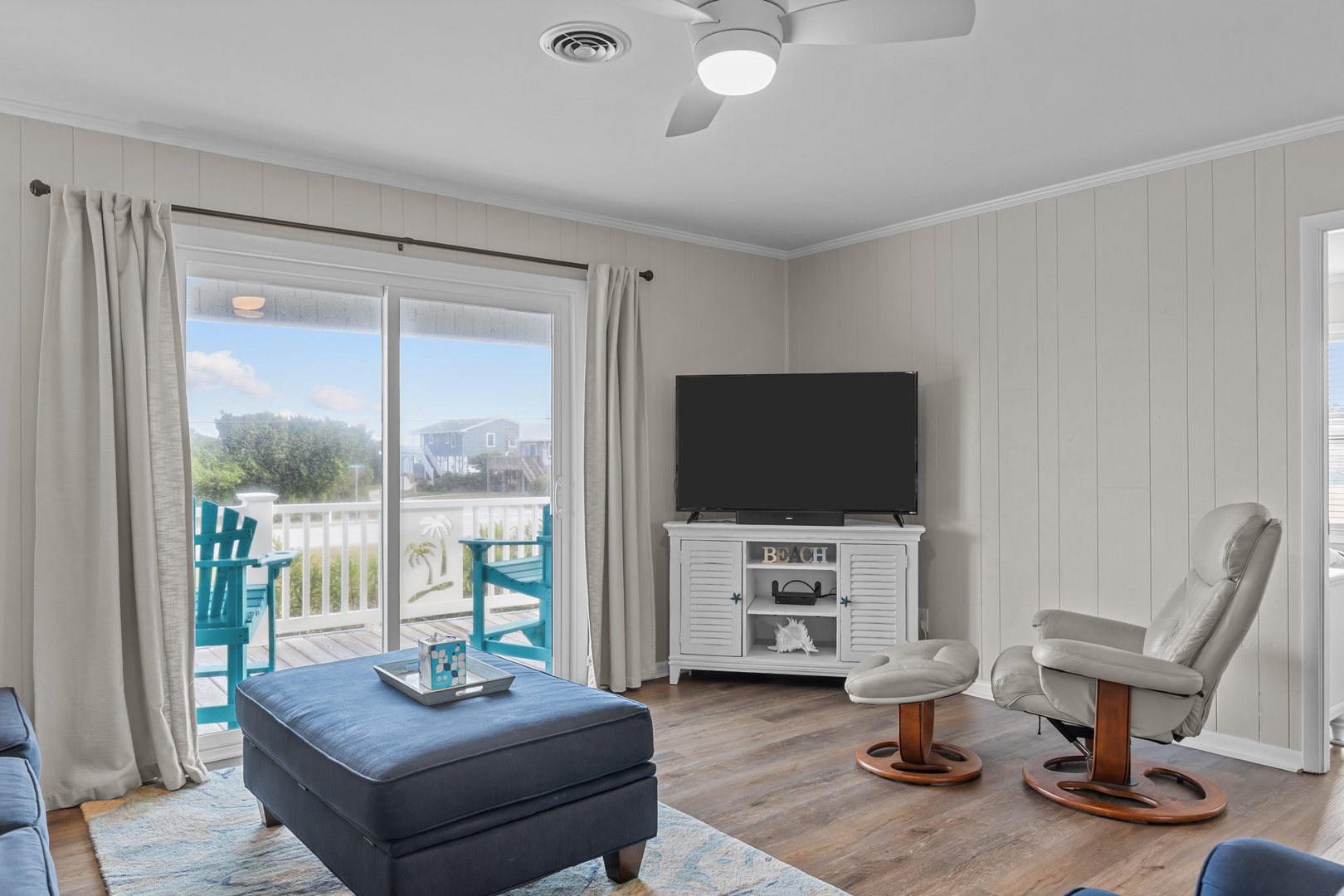 Relax in your bright living room with ocean views from your private balcony and comfortable seating.