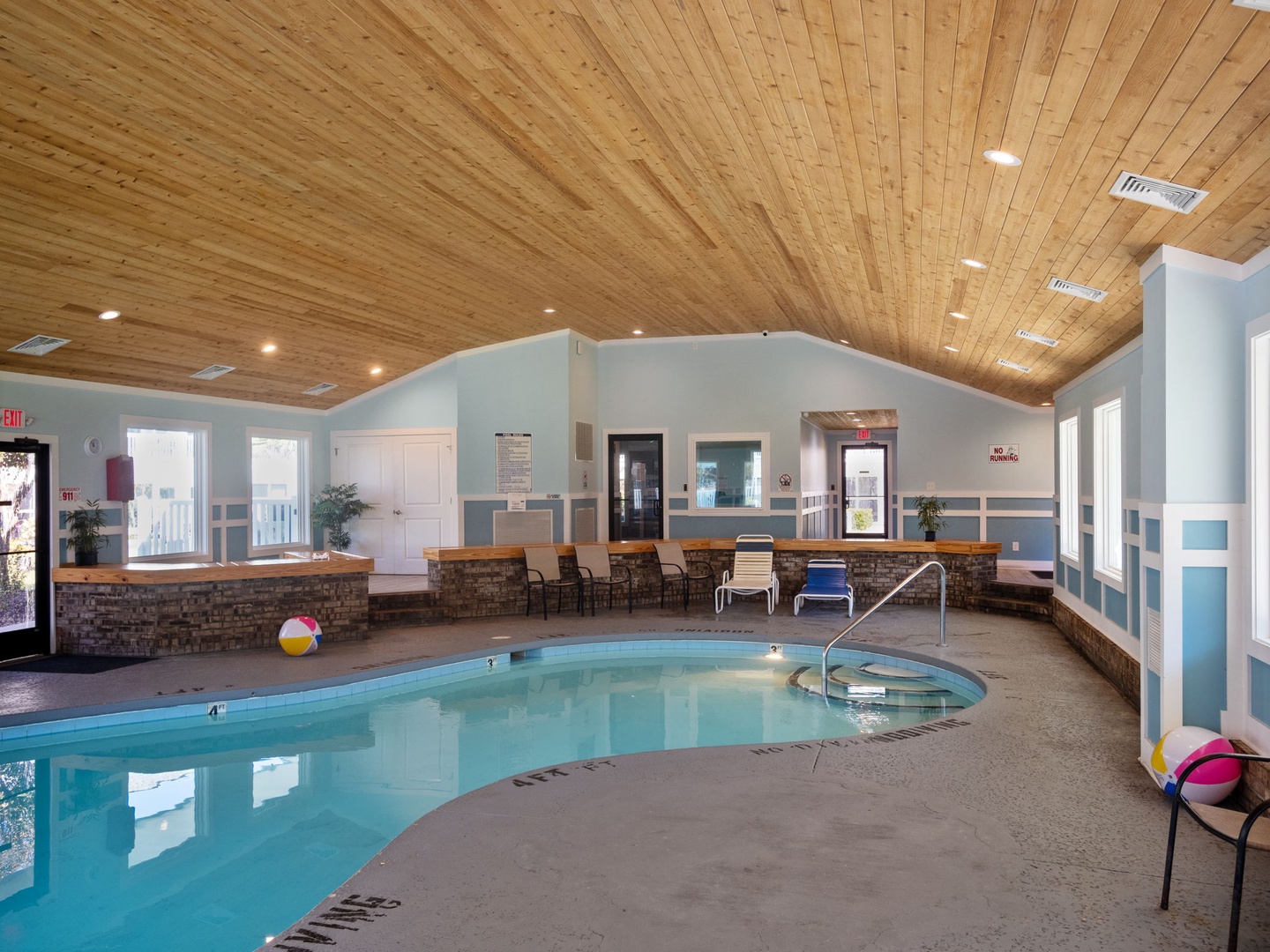 Dive into your private indoor pool sanctuary with soaring wood ceilings and cozy seating areas perfect for year-round relaxation.