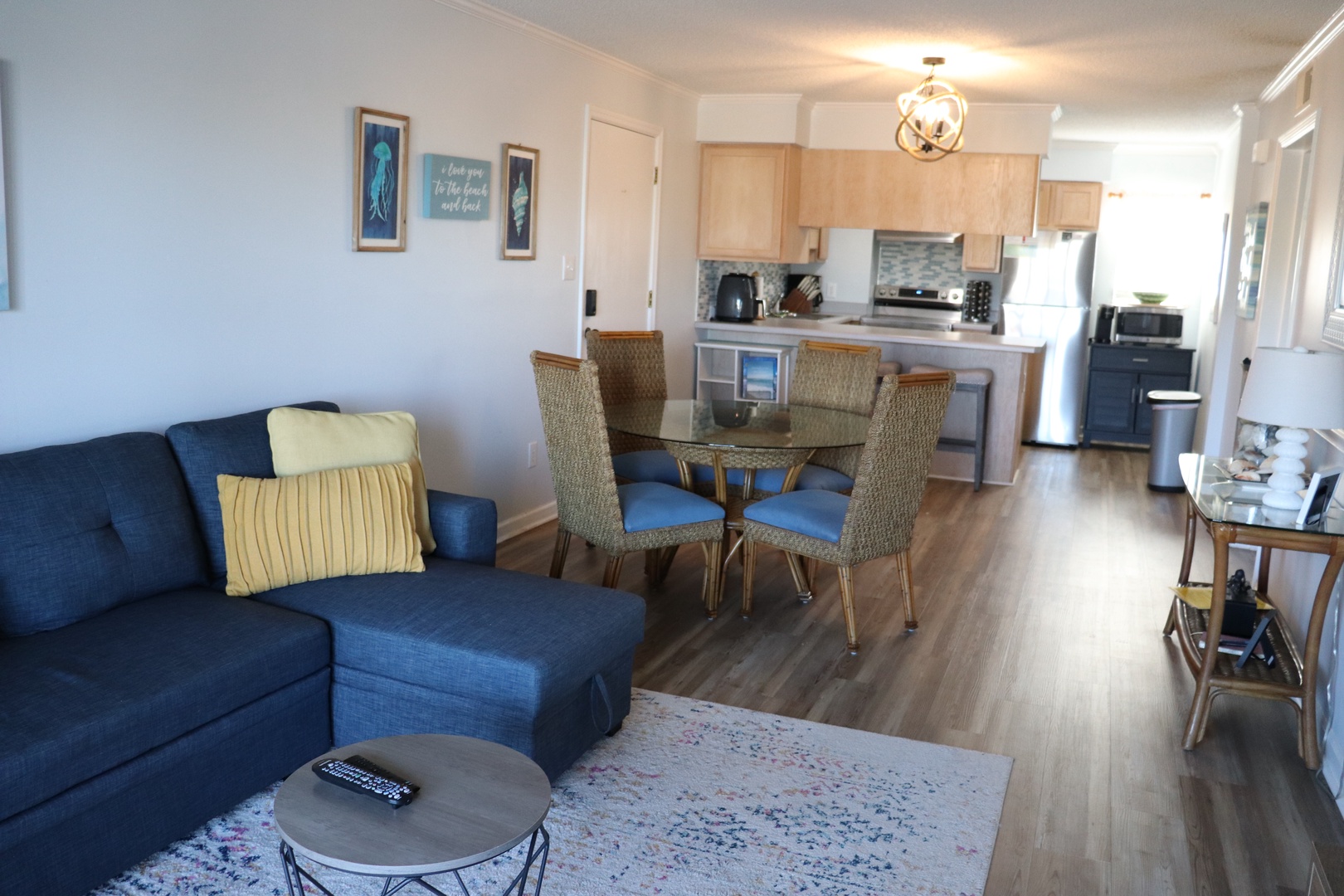 Relax in your bright open-concept space where coastal blues meet modern comfort, perfect for unwinding after beach adventures.