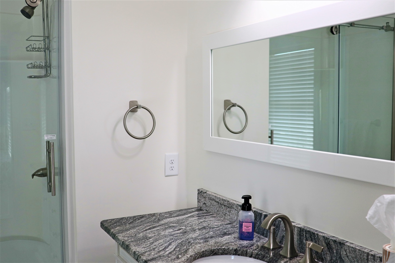 Your private bathroom features elegant marble countertops, a spacious glass shower, and modern finishes for a luxurious retreat.