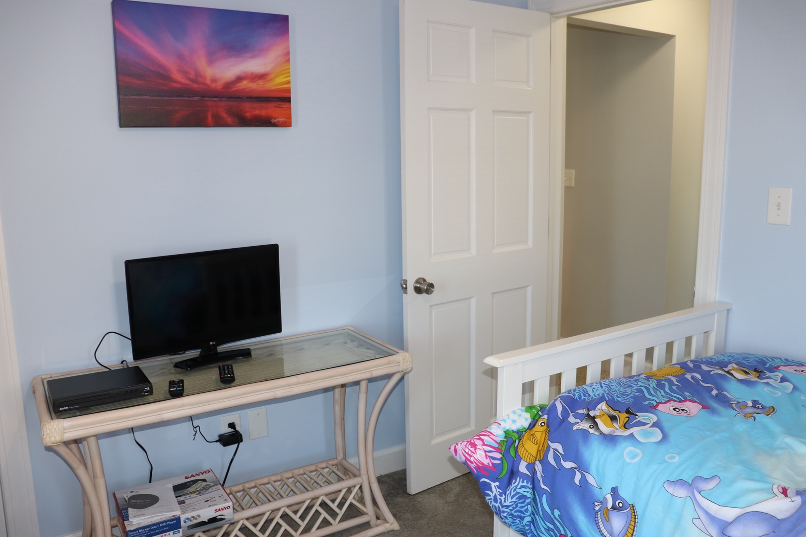 Your kids will love this bright bedroom with ocean-themed bedding and their own TV for movie nights.
