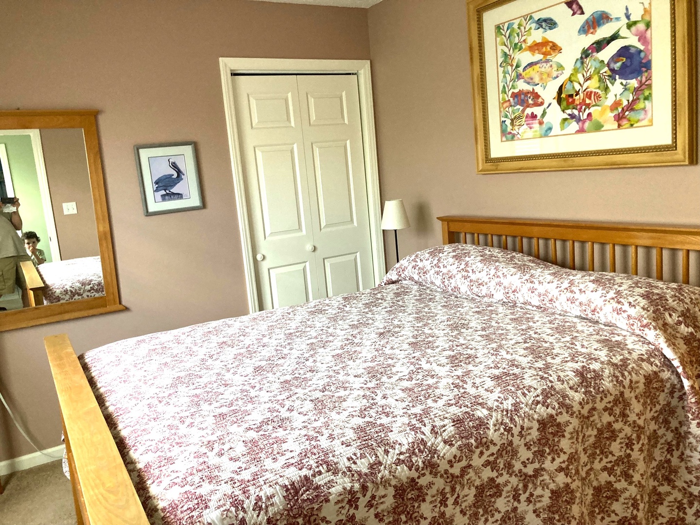 Rest peacefully in your welcoming bedroom with a comfortable bed and charming artwork creating a cozy atmosphere for your stay.