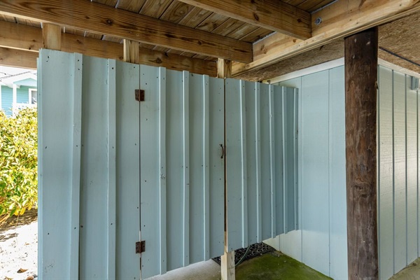 Enjoy your own private outdoor shower space with charming wooden beams overhead, perfect for refreshing rinses after beach days.
