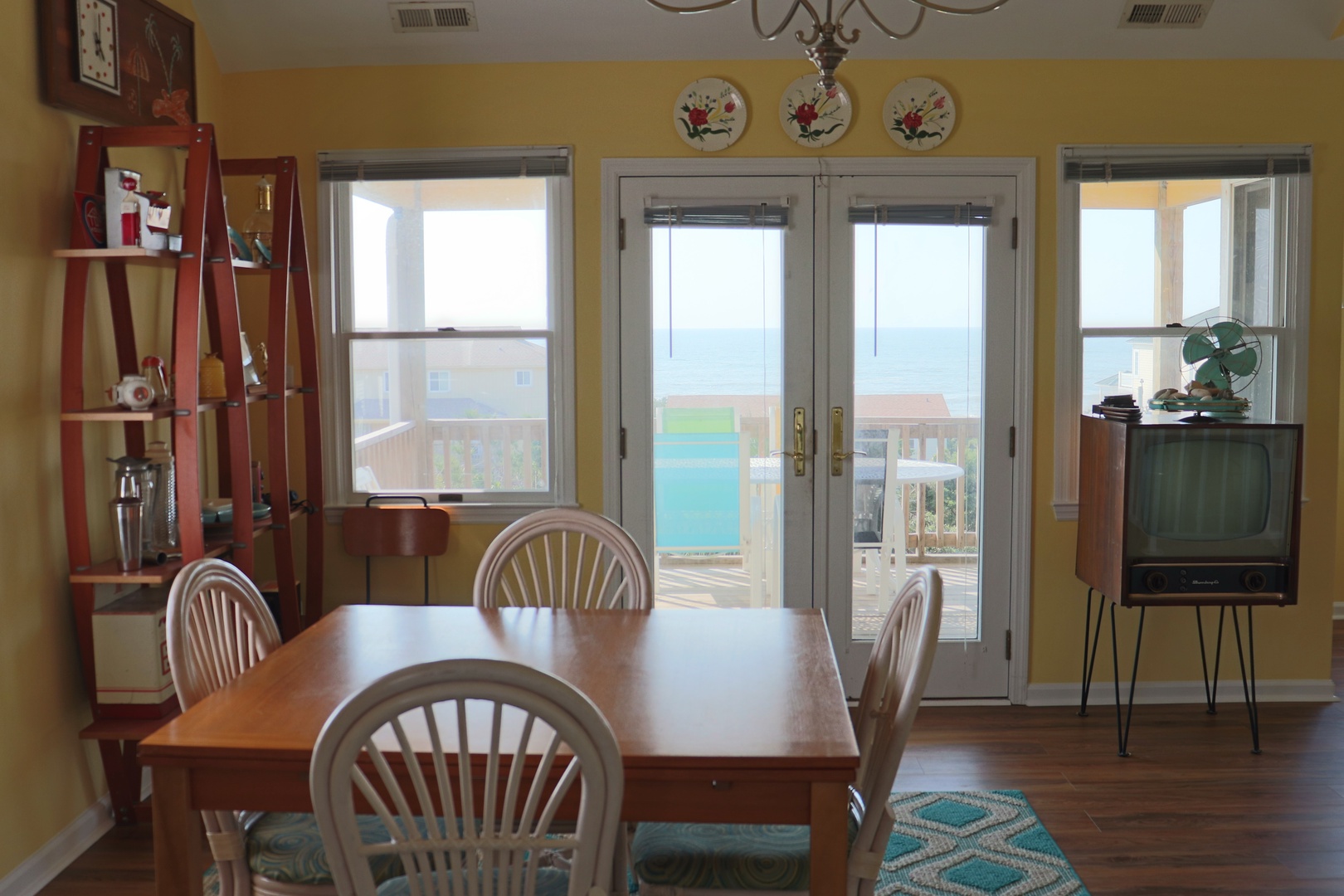 Your bright dining space opens to a private deck with stunning water views. Gather around the table for meals while soaking in coastal charm.