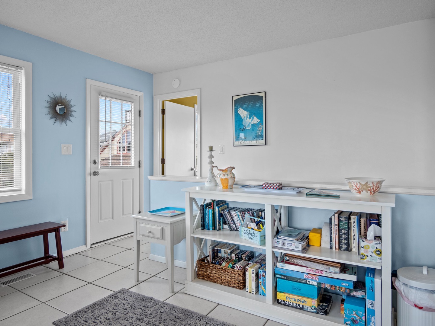Your cozy workspace features a sunny desk area with inspiring coastal artwork and games for quiet moments between adventures.
