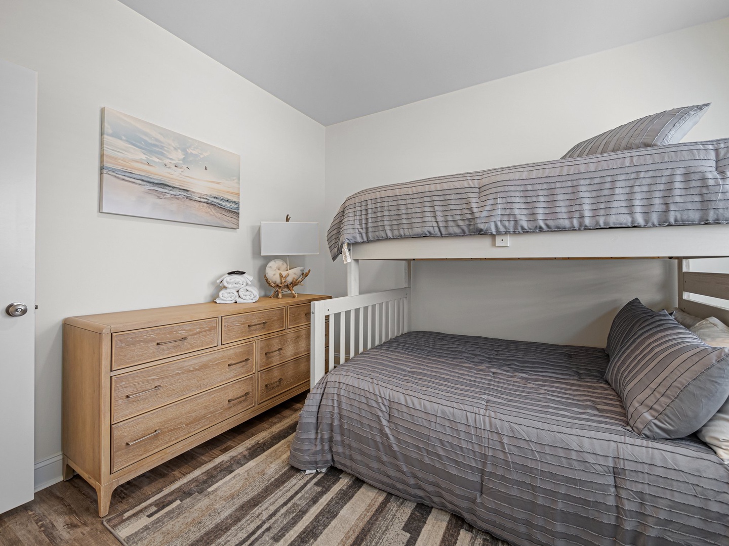 Your kids will love this cozy bunk bed room with soft gray linens and a spacious dresser for their belongings.