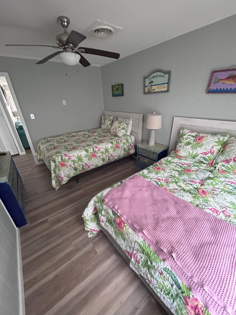 Drift into peaceful sleep with tropical-themed linens and gentle ceiling fan breezes in your comfortable twin bedroom.