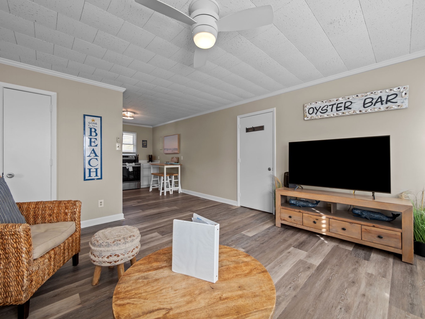 Relax in your coastal living room with beachy decor, comfy seating, and modern entertainment center for cozy nights in.