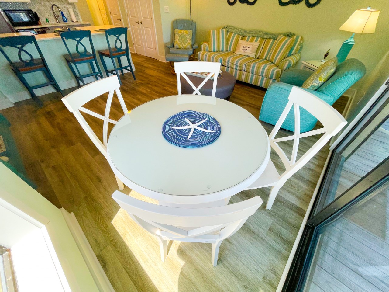 Your cheerful open-plan space flows from dining to living with coastal charm—perfect for morning coffee or evening games.