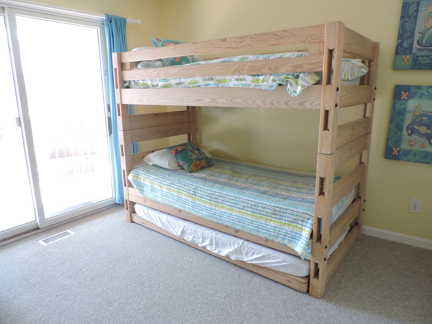 Your kids will love this fun bunk bed setup with colorful bedding and cheerful wall art, perfect for creating magical vacation memories together.