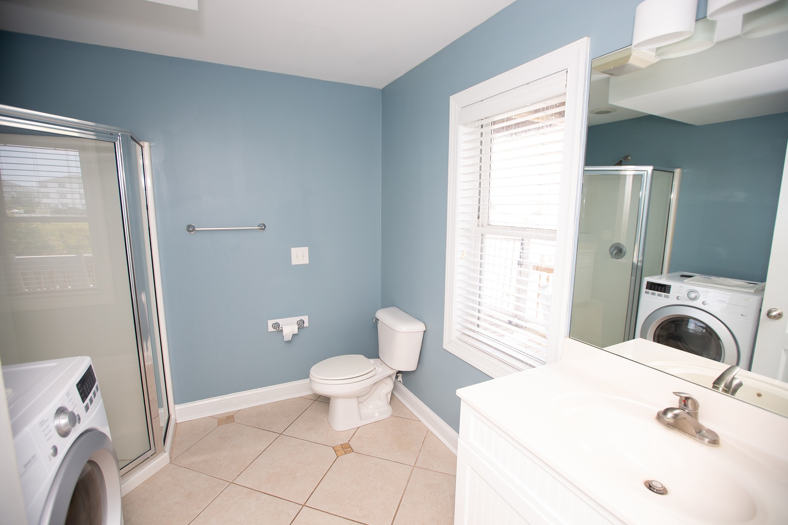 Your bright bathroom features a refreshing shower, plus convenient in-room washer and dryer for effortless laundry during your stay.
