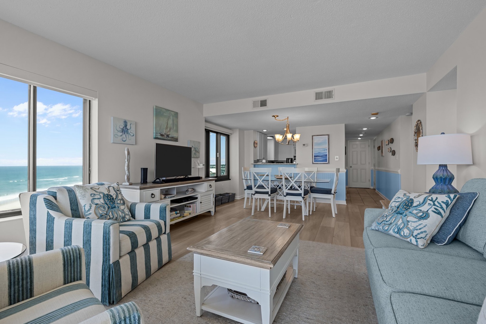 Relax in your beautifully appointed oceanfront living space, where coastal blues and stripes create the perfect beachside retreat.