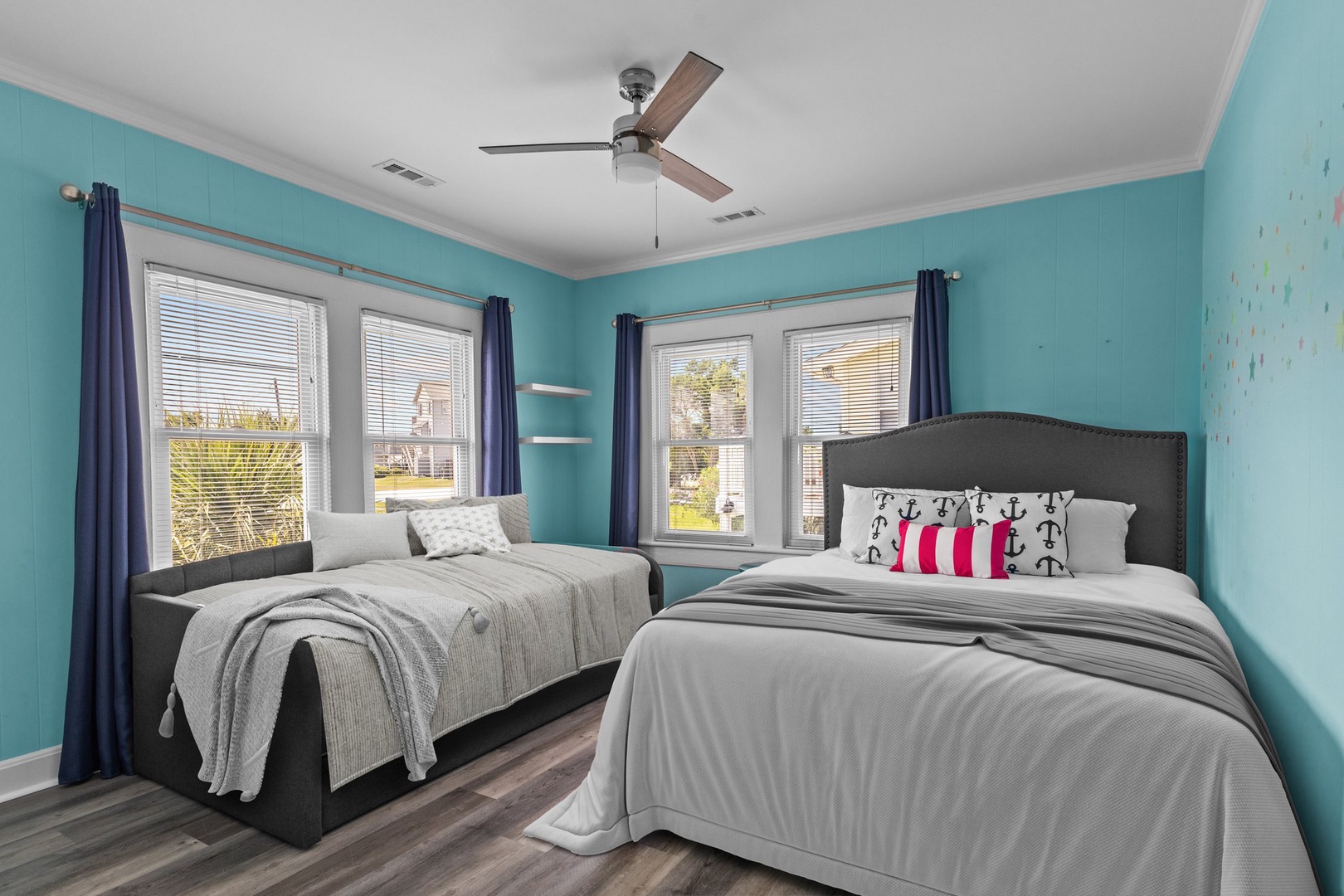 Wake up refreshed in your cheerful turquoise bedroom with two comfortable beds, perfect for families or friends traveling together.