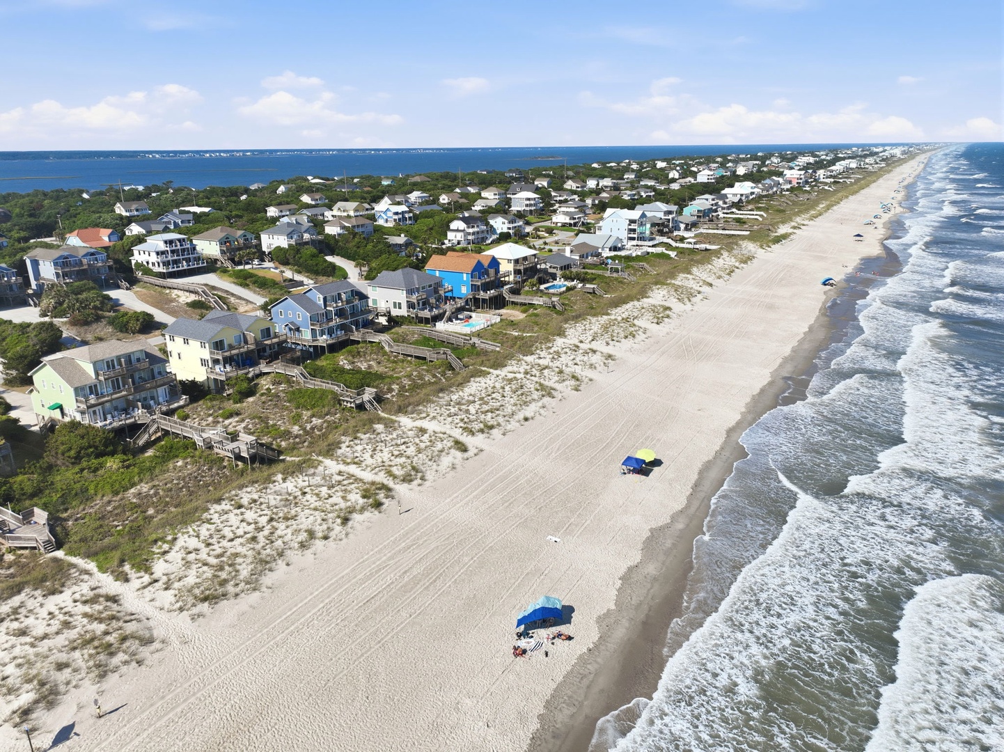 This coastal property sits on a pristine stretch of sandy shoreline with wide beaches and rolling waves, offering a peaceful oceanfront location perfect for a beachside getaway.