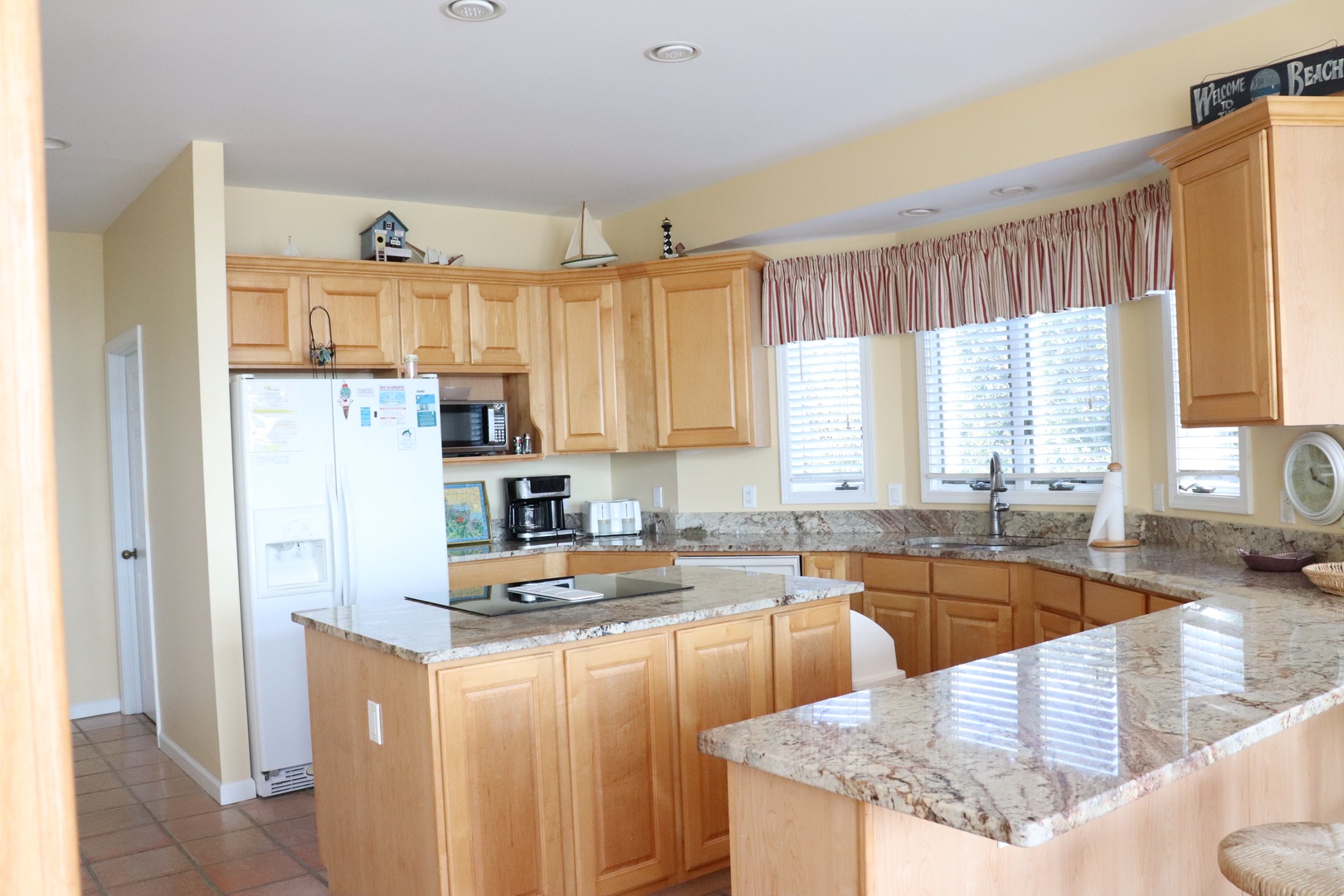 Your fully equipped kitchen features granite countertops, modern appliances, and ample space for preparing meals during your stay.