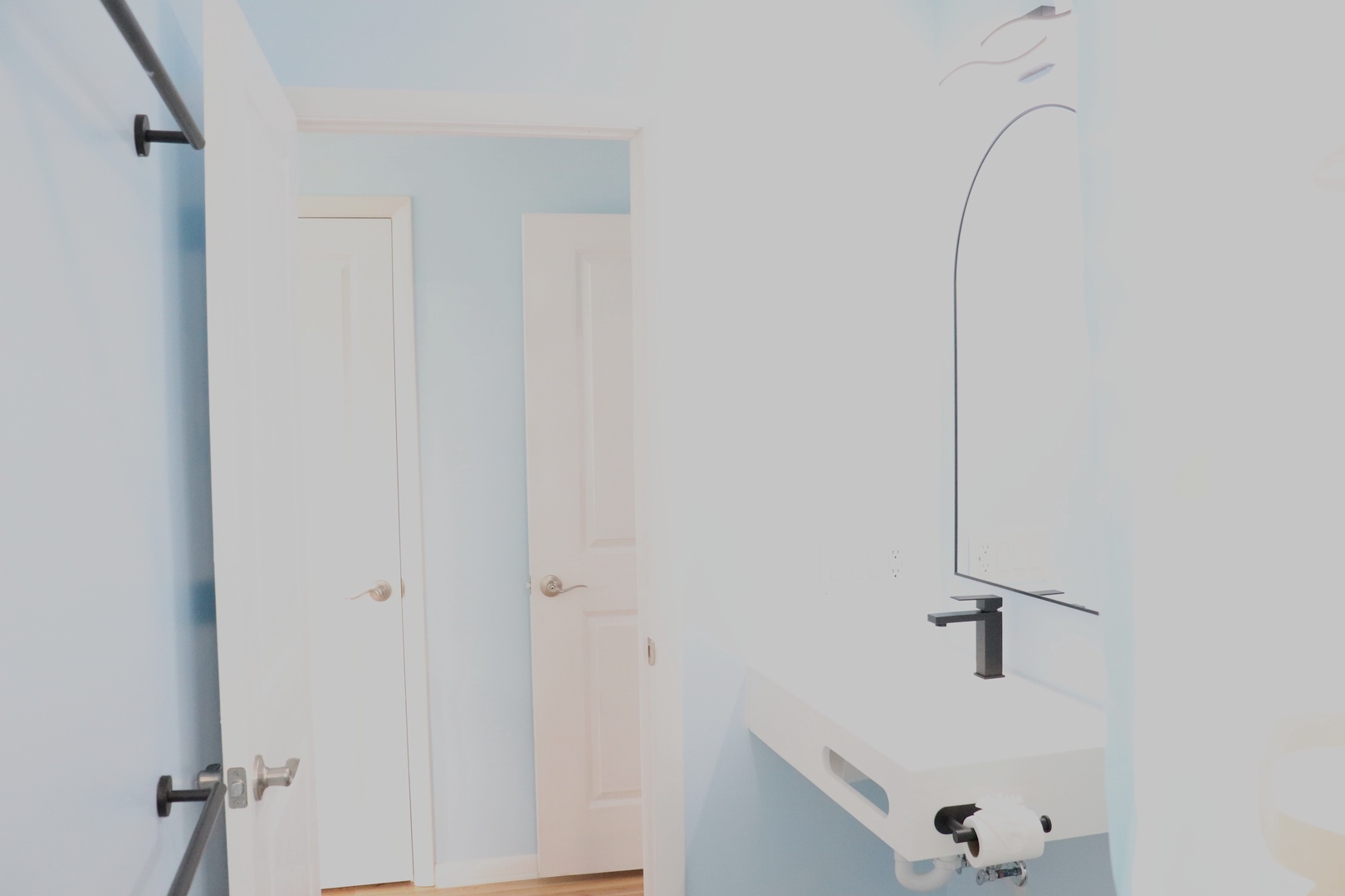 Clean, modern bathroom with sleek fixtures and soothing blue accents, designed with your comfort in mind for a refreshing start to each day.