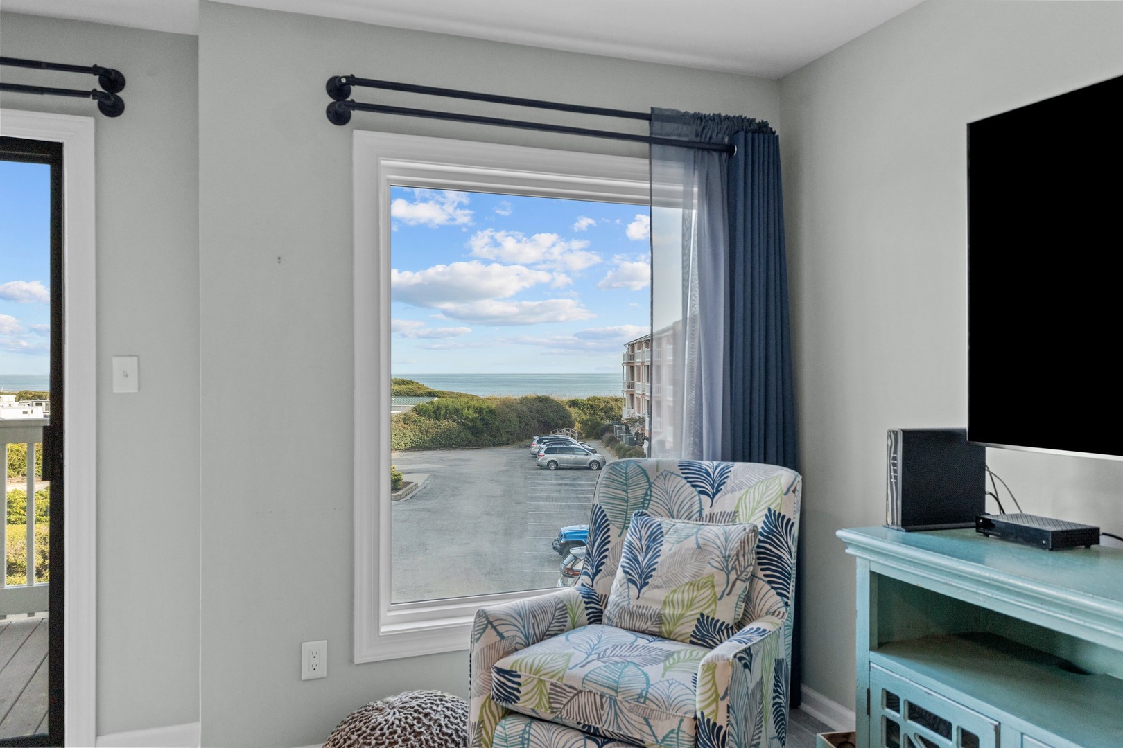Unwind in your coastal retreat with ocean views from your window seat, where tropical patterns meet serene blue skies.