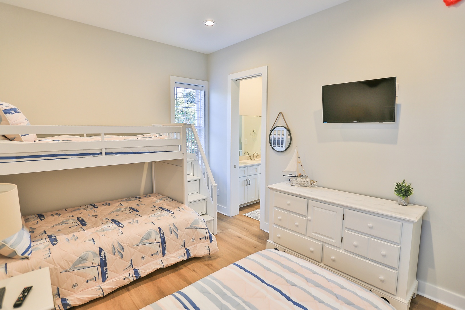 Your kids will love this bright bedroom with its cozy bunk bed and extra twin bed, perfect for family adventures.