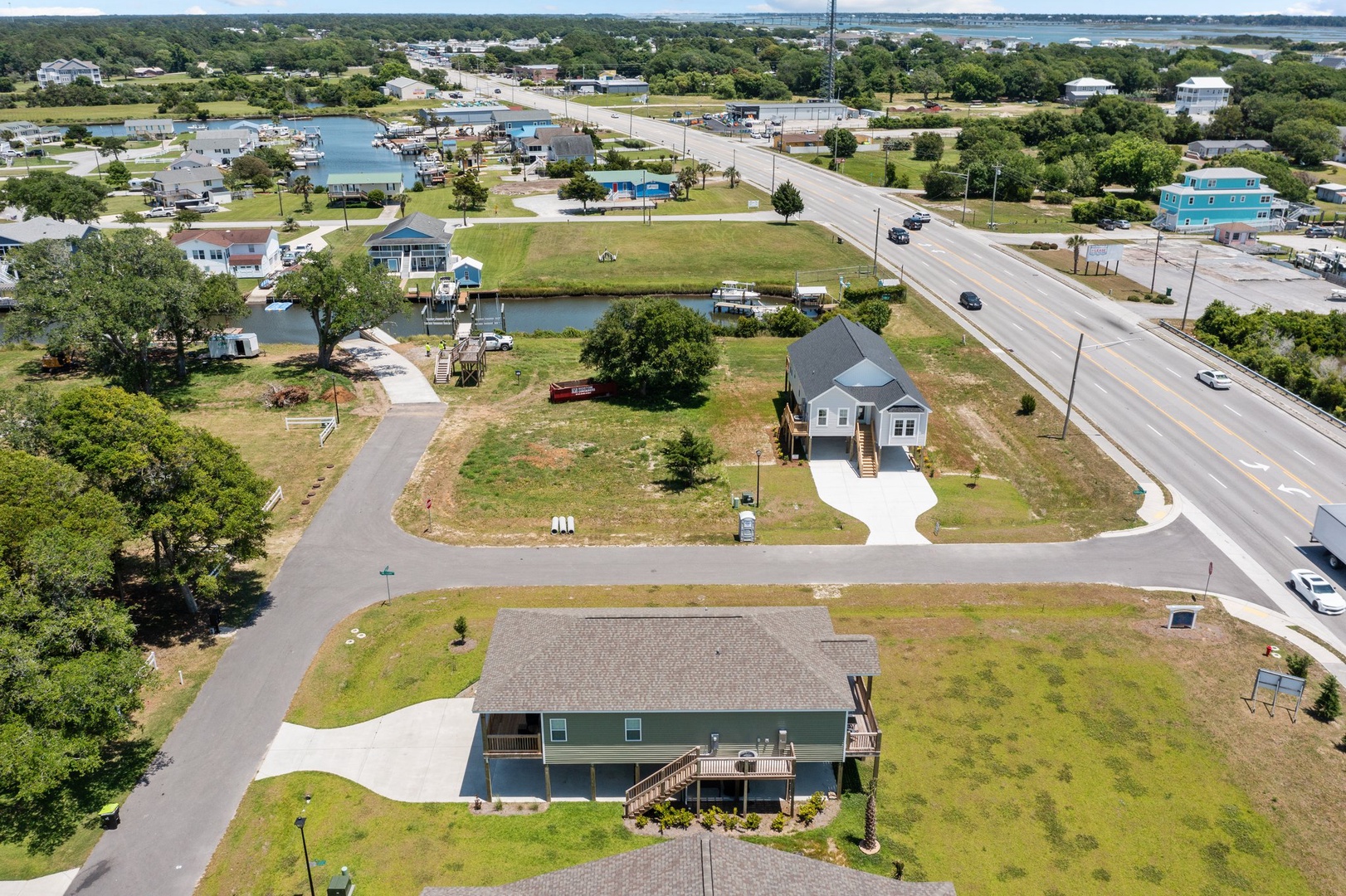Aerial view of waterfront vacation rental community with marina access and coastal living amenities in peaceful residential setting.