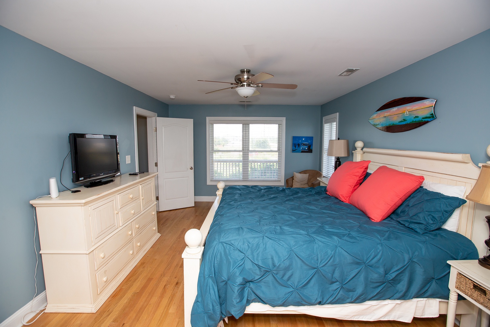 Drift into peaceful sleep in your spacious bedroom featuring coastal-inspired blue décor, comfortable bedding, and entertainment for cozy evenings in.